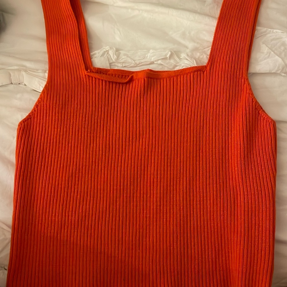This tank top is so cute and fun. Perfect for U.T. games. Its color is orange.